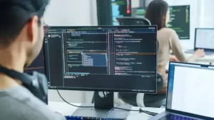 Web developer working with website code on a computer monitor